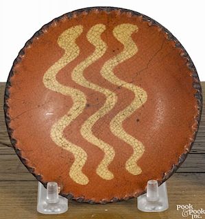 Miniature Pennsylvania redware cup plate, 19th c., with yellow slip wavy lines, 3 7/8'' dia.