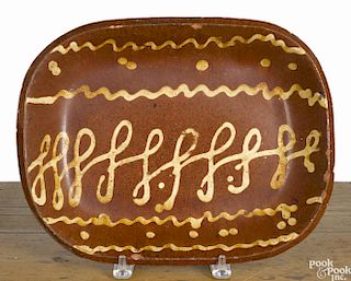 Redware loaf dish, 19th c., probably English, with yellow slip loop decoration, 10 3/8'' h.