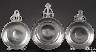 Three New England pewter porringers, early/mid 19th c., two - 4'' dia., 4 1/2'' dia.