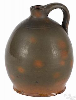 Pennsylvania redware jug, 19th c., with orange and green glaze, 6 3/4'' h.