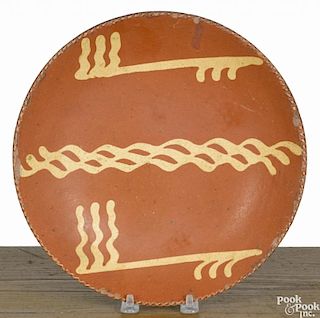 Pennsylvania redware plate, 19th c., with yellow slip decoration, 9 3/4'' dia.