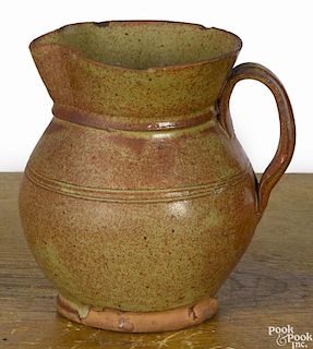 New England redware pitcher, 19th c., probably Maine, with green and iron red glaze, 6 1/8'' h.
