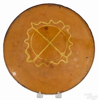 Huntington, Long Island redware charger, 19th c., with a central slip circle and star device