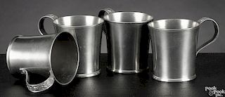 Set of four New England pewter beakers, early/mid 19th c., with cast floral handles, 3'' h.
