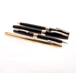 Bolígrafo, lapicero y dos plumas fuente de la firma Sheaffer. Cuerpo en acero dorado y resina en color negro. Punto en oro amari...