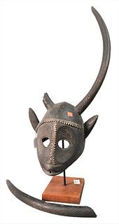 African Mask or Headdress, having heavy metal mounts and large horns, height 27 inches