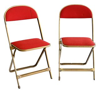 Set of Twelve Mid Century Modern Folding Chairs, having gold painted metal frames and red upholstery.