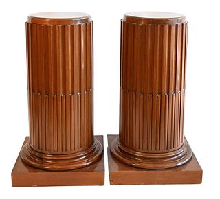 Pair Mahogany Reeded Column Pedestals on molded bases, height 38.25 inches, diameter of top 15 inches.