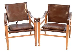 Pair of Safari Chairs in the Style of Kaare Klint, having leather seats and backs and leather strap arms, seat height, 14.5 inches, height to top of b