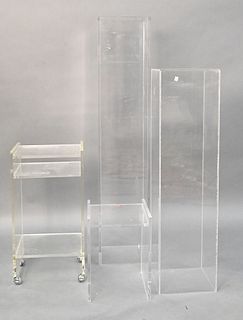 Four Piece Lucite Group, to include two pedestals and two small stands (one pedestal is missing top), tallest in height 47 1/2 inches.