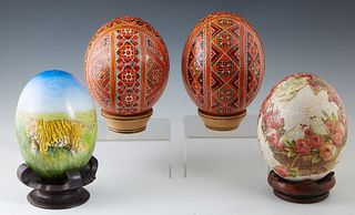 Group of Four Ostrich Eggs, 20th c., two of Ukrainian Easter Style; with bright geometric decoration; one with a hand painted tiger in a landscape; an