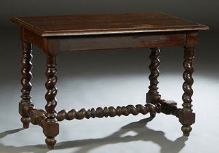 French Louis XIII Style Carved Oak Library Table, c. 1880, the sloping edge top over a wide skirt, on rope twist legs joined by an H-form block and ro