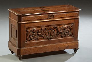 Diminutive French Provincial Henri II Style Carved Oak Coffer, c. 1880, the canted corner lifting top over a leaf and floral carved front panel flanke