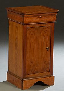 French Louis Philippe Carved Cherry Nightstand, 20th c., the rounded corner top over a frieze drawer and a long cupboard door, on a plinth base, H.- 2