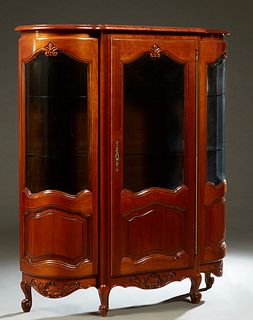 French Louis XV Style Carved Cherry Curved Glass Vitrine, 20th c., the breakfront crown above a center door with a beveled glazed upper panel over a f