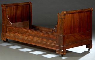 French Louis Philippe Carved Mahogany Lit du Coin, 19th c., the cylindrical sleigh ends, on stepped block supports, flanking a front rail with scroll 