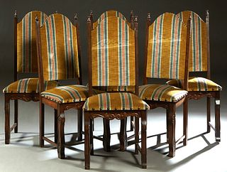 Set of Six Louis XIV Style Carved Oak Dining Chairs, 20th c., the arched canted back with two turned finials, over a trapezoidal cushioned seat, on re