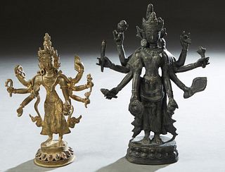 Two Bronze Standing Bodhisattva Figures early 20th c., one gilt on a pierced relief circular base; the other patinated, on an integral relief base, Pa