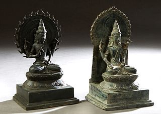 Pair of Bronze Seated Bodhisattva Figures, 20th c., with coronas, on lotus form cushions, on stepped integral bases, H.- 11 1/4 in., W.- 6 3/4 in., D.