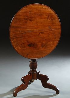 French Louis Philippe Carved Cherry Tilt Top Table, 19th c., the reeded edge dished circular top on a tapered urn form support, to tripodal cabriole l