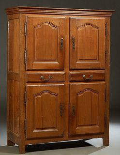French Provincial Louis XIV Style Carved Cherry and Oak Homme Debout, early 19th c., the stepped crown over a fielded panel cupboard door with a long 
