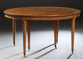 French Louis XVI Style Carved Walnut Oval Dining Table, 20th c., the oval top over a wide skirt, on tapered cylindrical legs with metal cup casters, o
