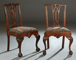 Pair of Chippendale Style Carved Mahogany Side Chairs, 20th c. the arched serpentine crest rail over a pierced splat, to a trapezoidal cushioned seat,