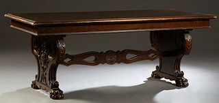 English Carved Mahogany Dining Table, early 20th c., the stepped top on a carved trestle base with paw feet, joined by a pierced vertical stretcher, w