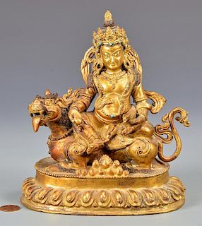 Sino-Tibetan Gilt Bronze Deity on Lion