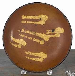 Redware charger, 19th c., with yellow slip splotches, 11 1/4'' dia.