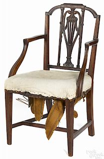 Philadelphia Federal mahogany armchair, ca. 1800, with a carved back and stretcher base.