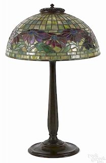 Tiffany Studios patinated bronze table lamp with a leaded glass poinsettia shade, the shade signed