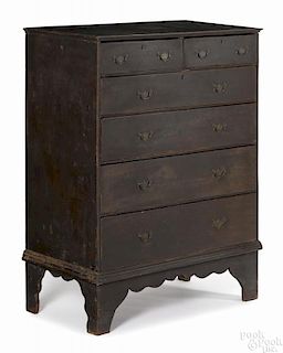 New England painted pine semi-tall chest, mid 18th c., retaining a later Spanish brown surface