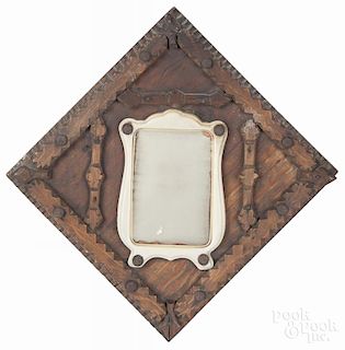 Tramp art carved mirror, ca. 1900, with an applied mirror and a celluloid frame, 13 1/4'' h.