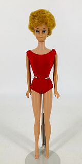 Blonde Bubble Cut Barbie wearing a red one piece bathing suit. No lipstick, fingers painted only. Barbie has a red stain on her foot. Also has a split