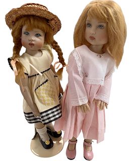 Lot of 2 Kish & Co dolls in hard vinyl with painted faces, five-jointed. Doll w/braids is circa 2003 and is approx 11" tall. Doll in pink is approx 12