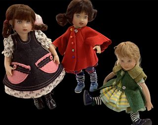 Lot of 3 Kish & Co dolls made from hard vinyl @ approx 8" tall. Brunette in pink & black has outfit with Kish & Co logo. Dolls are five-jointed.