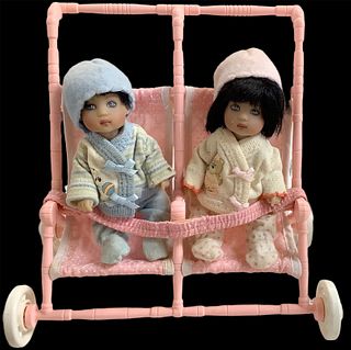 2011 Kish & Co baby dolls (2) @ 5" tall in hard vinyl. Boy and girl are five-jointed and include a double stroller accessory with moveable wheels.