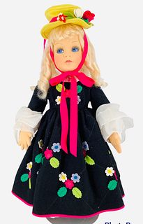 21" Anili has a pressed felt face with blue side glancing painted eyes with blond curled wig in felt tagged dress, in good condition, no COA.