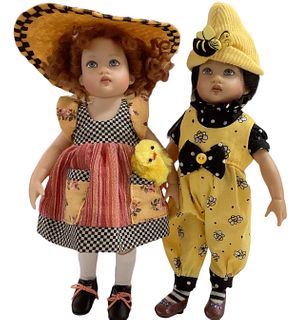 Lot of 2 Kish & Co dolls @ 8" tall in hard vinyl w/ painted faces. Brunette doll has a bee themed outfit and redhead has a tiny yellow chick accessory