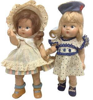 Lot of 2 Toddles composition dolls @ approx 8" tall. Some crazing to both faces, arms and bodies. Doll w/bonnet has age wear to outfit, doll in blue d