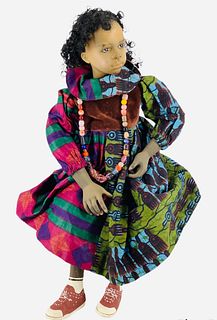 17" porcelain Uta Brauser sitting doll. Painted facial features, small paint chips/rubs on legs and shoes.