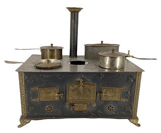 17" x 11 1/2" Early German Doll Tin Stove with Tin pan accessories. Shows some wear and is heavy regarding shipping.