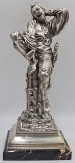 Silvered Metal Jester Seated on a Column.
