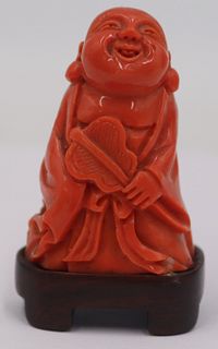 Carved Salmon Coral of a Buddha with Fan.