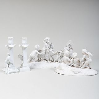 Two Paris Biscuit Figure Groups with Putti and Two of Candlesticks