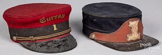 Two fire department dress caps