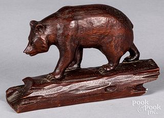 Carved bear, early 20th, crossing a log