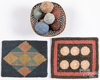 Two small hooked rugs, a basket and fabric balls