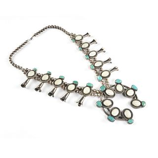 A NAVAJO TRIBAL SILVER, TURQUOISE, AND MOTHER-OF-PEARL SQUASH BLOSSOM NECKLACE, SIGNED R.T. FRAGUA, MID 20TH CENTURY,